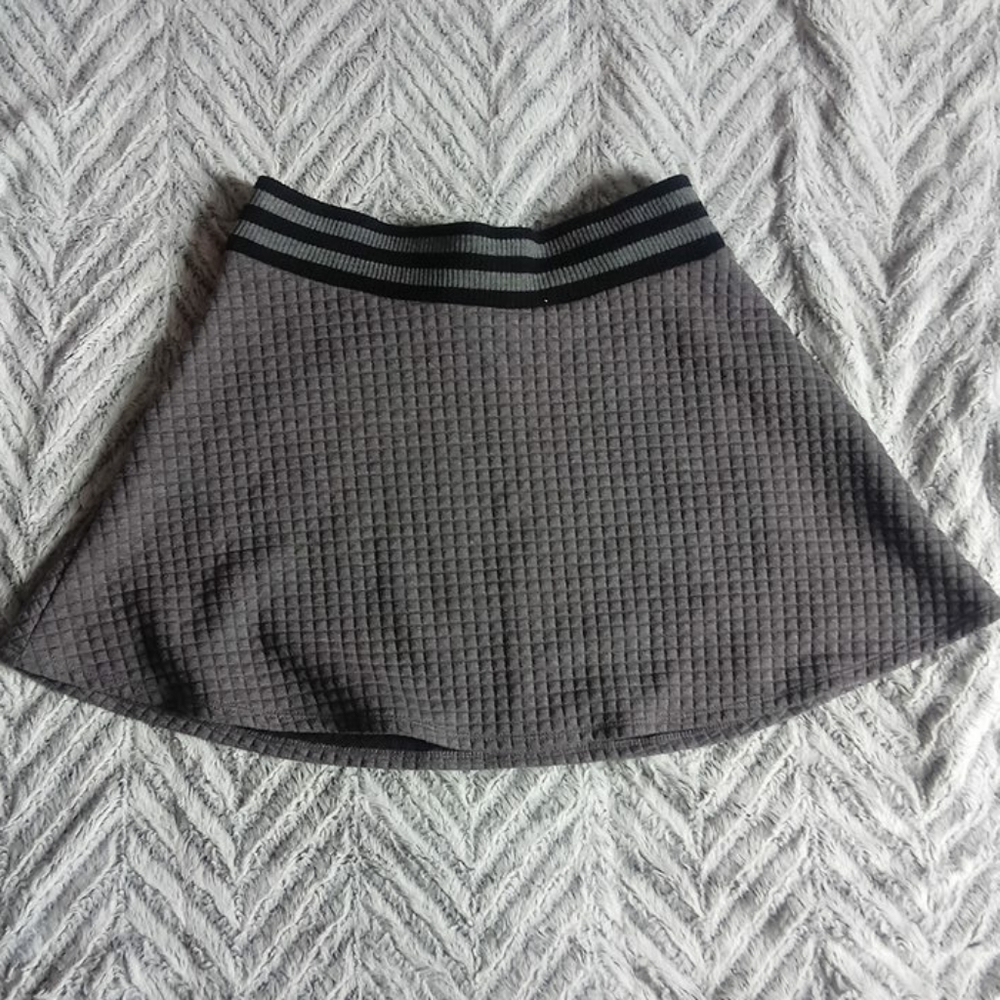 A thigh high gray skirt